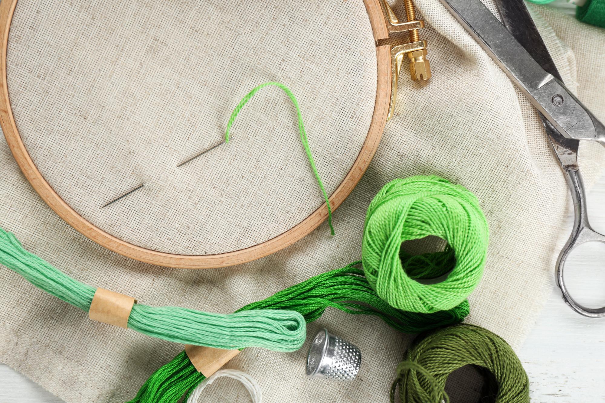 Studio workspace with embroidery hoops and threads neatly organized