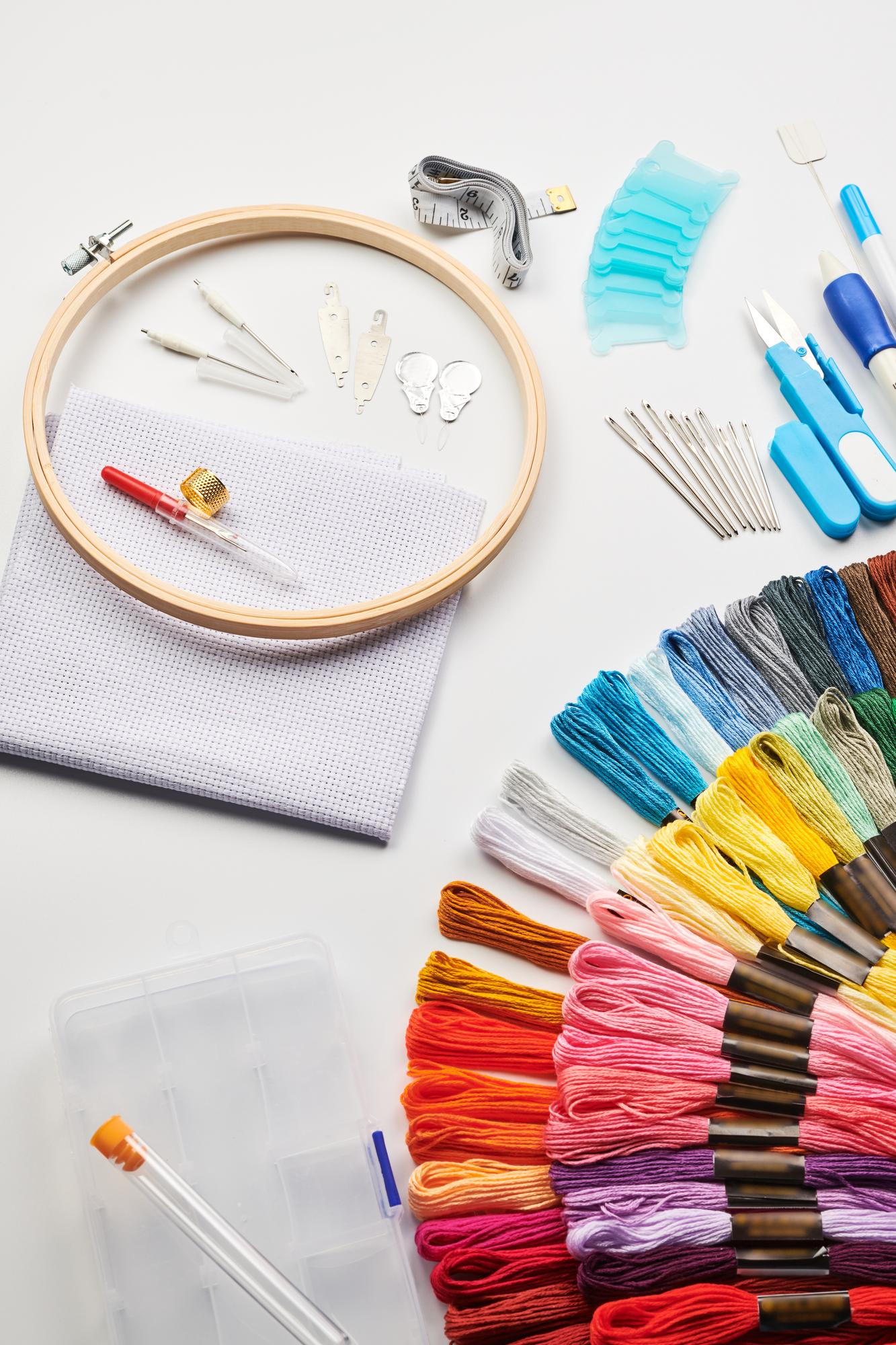 Selection of embroidered swatches laid out on table
