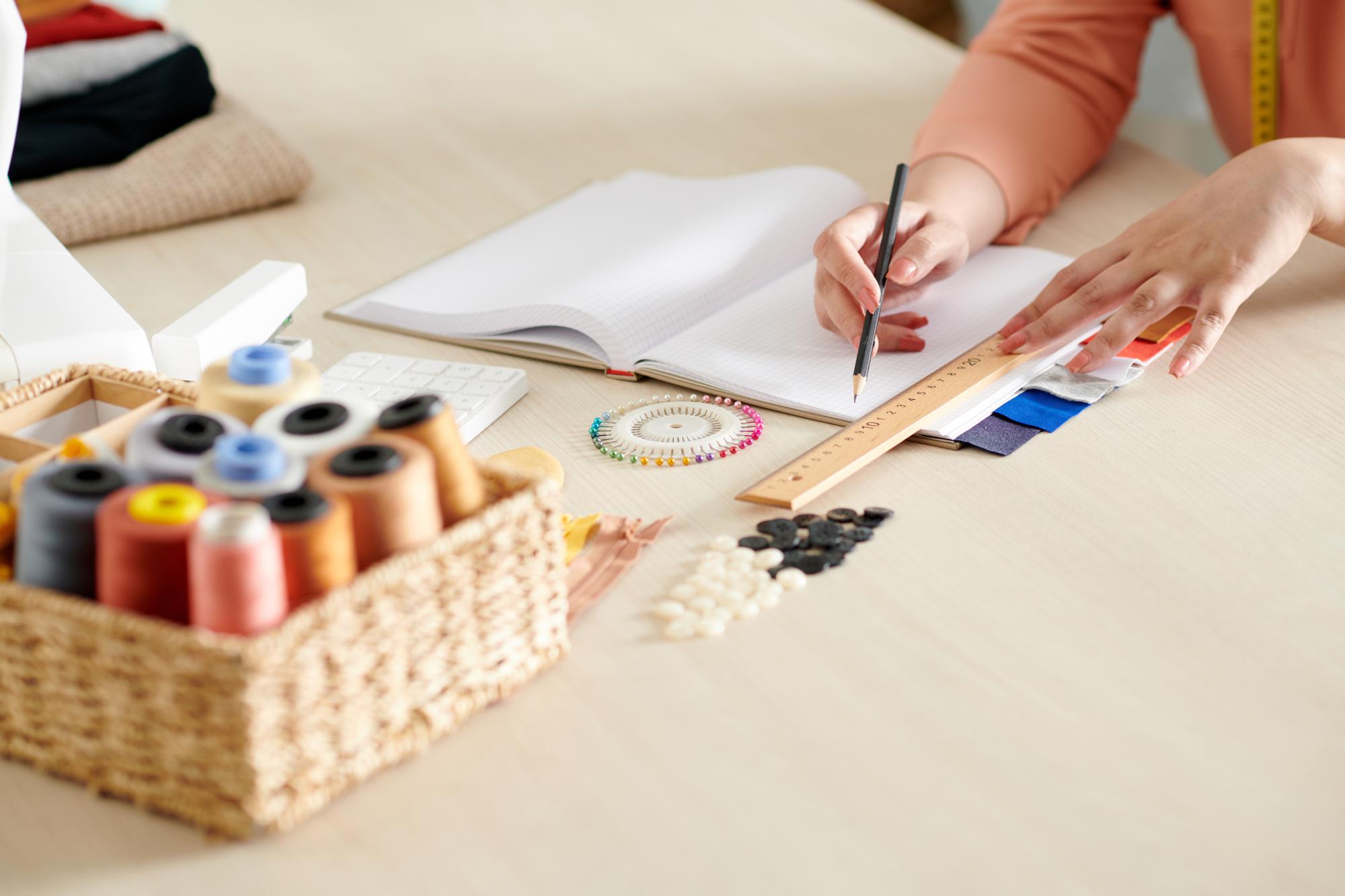 Designer sketching embroidery patterns