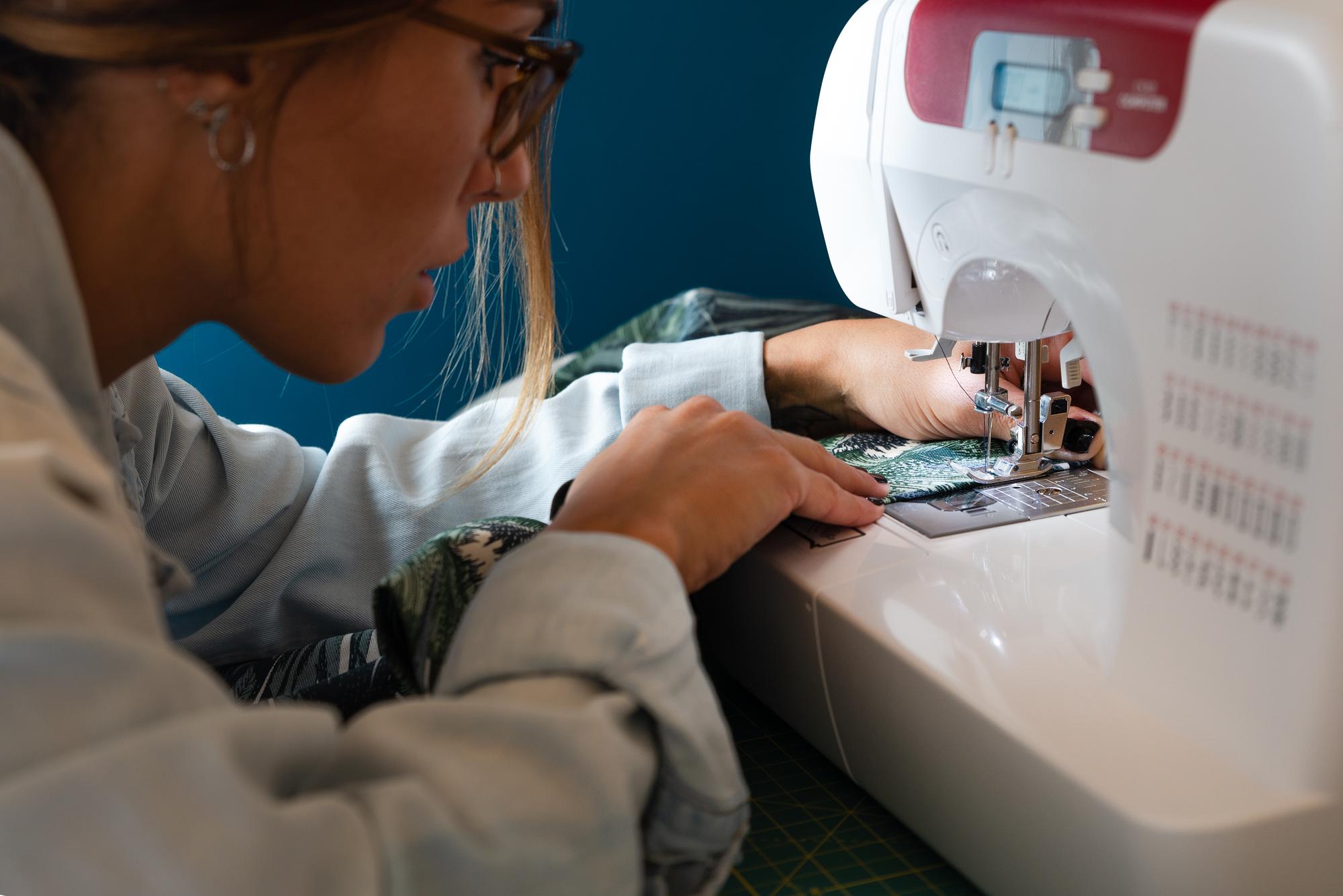 Technician preparing embroidery machine and threads